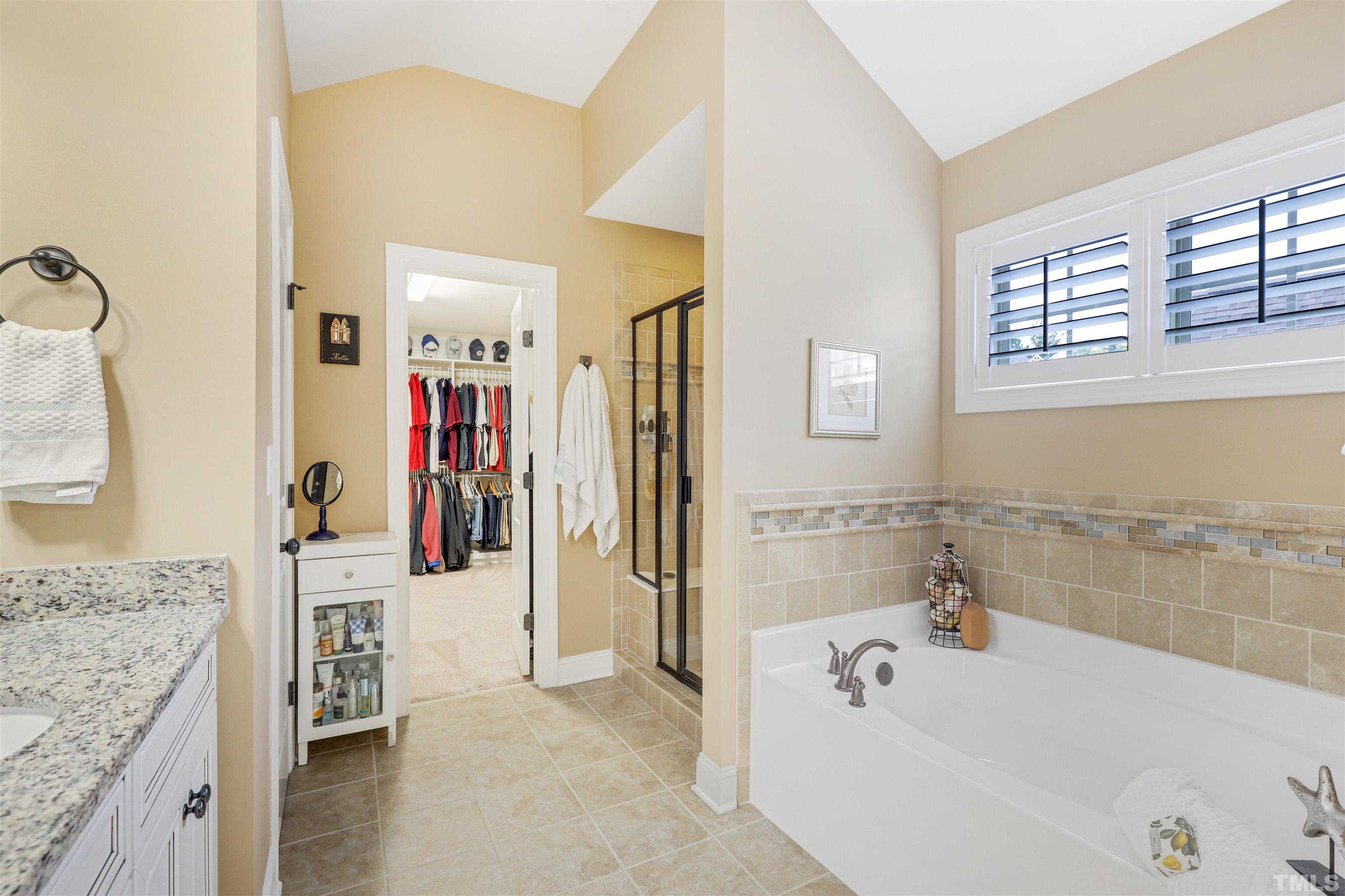 4312 Glengrove Road Raleigh, NC 27616 - Photo 25 of 50 a bathroom with a granite countertop tub sink and mirror