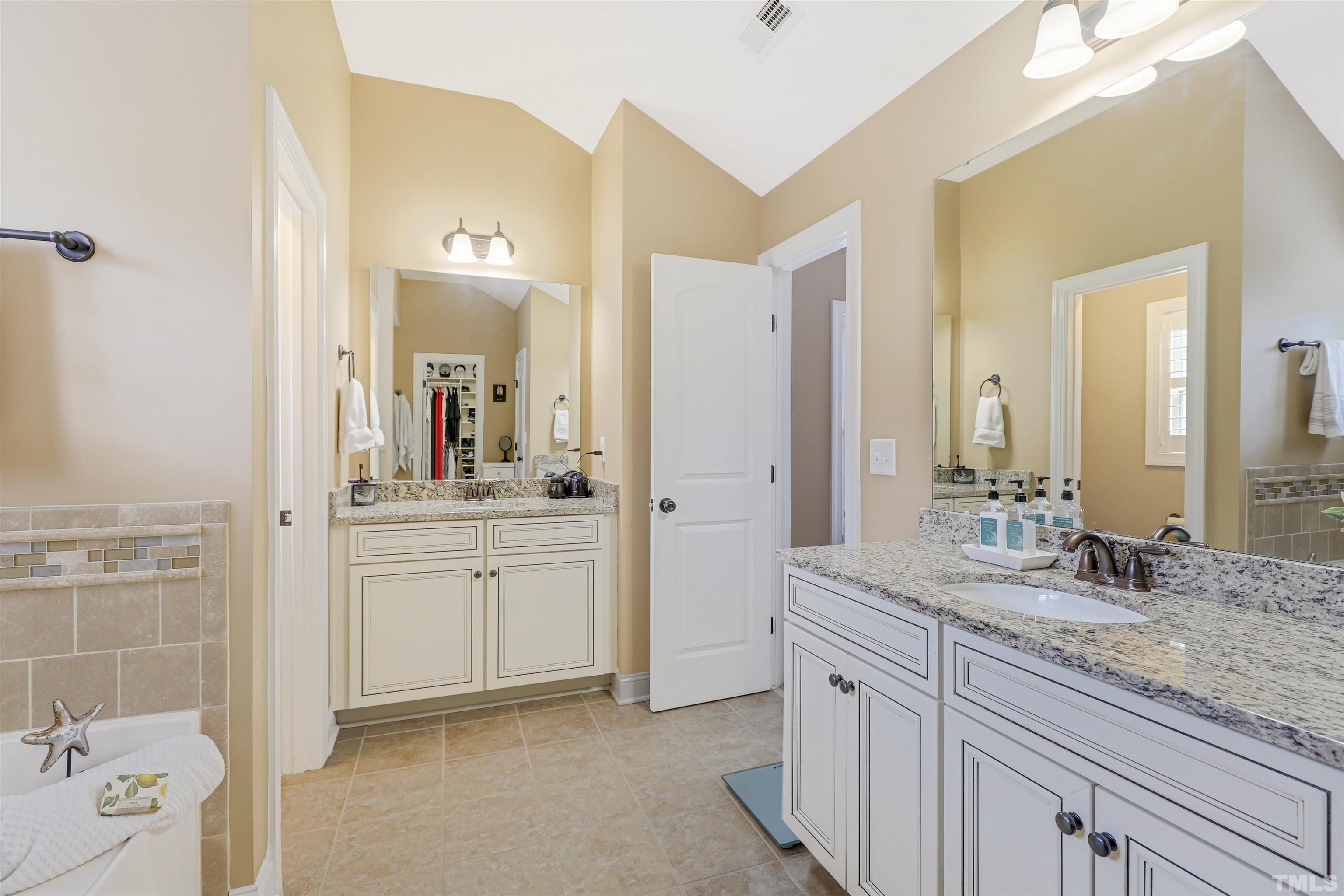 4312 Glengrove Road Raleigh, NC 27616 - Photo 26 of 50 a spacious bathroom with a granite countertop sink mirror and shower