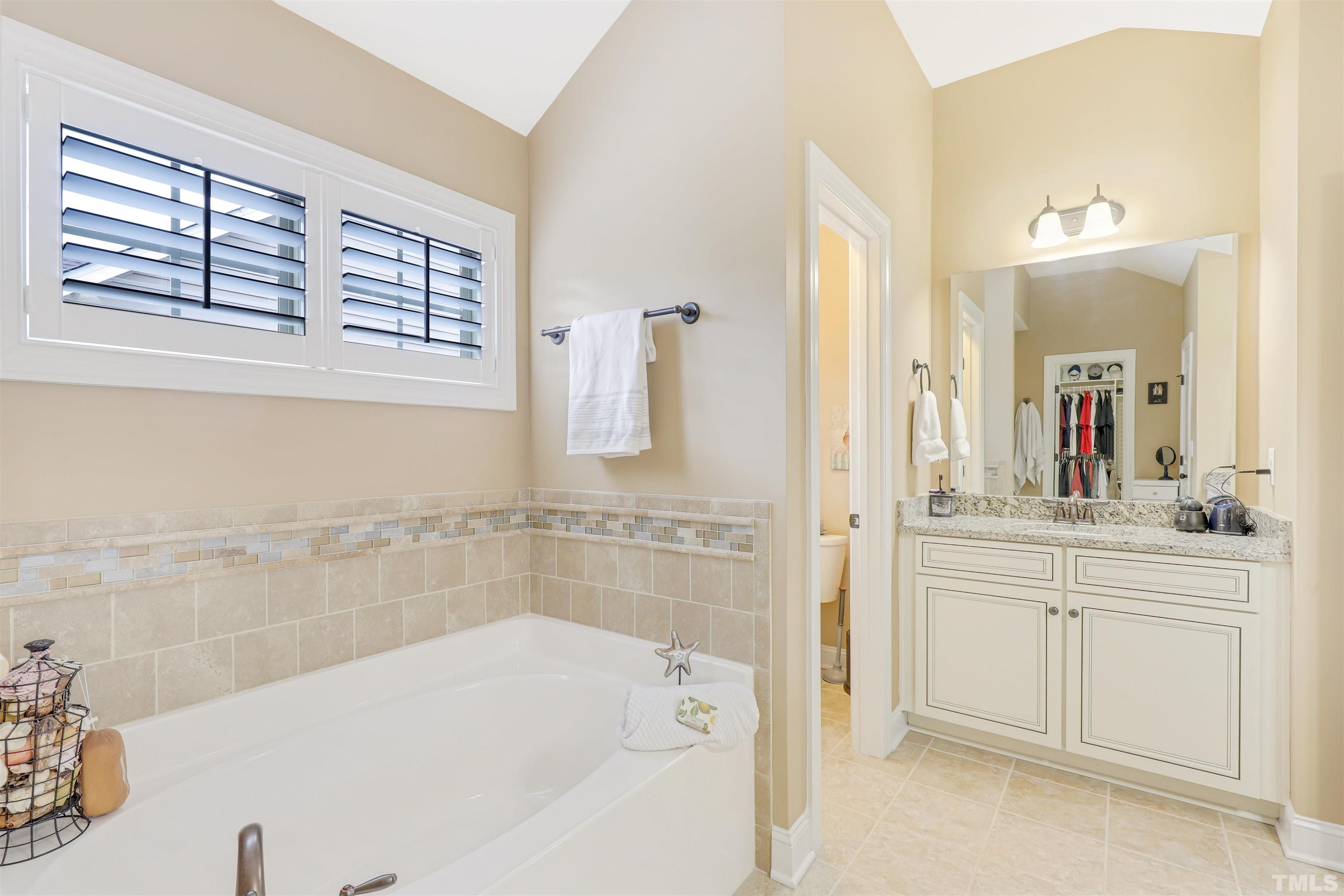4312 Glengrove Road Raleigh, NC 27616 - Photo 27 of 50 a bathroom with a tub sink and mirror