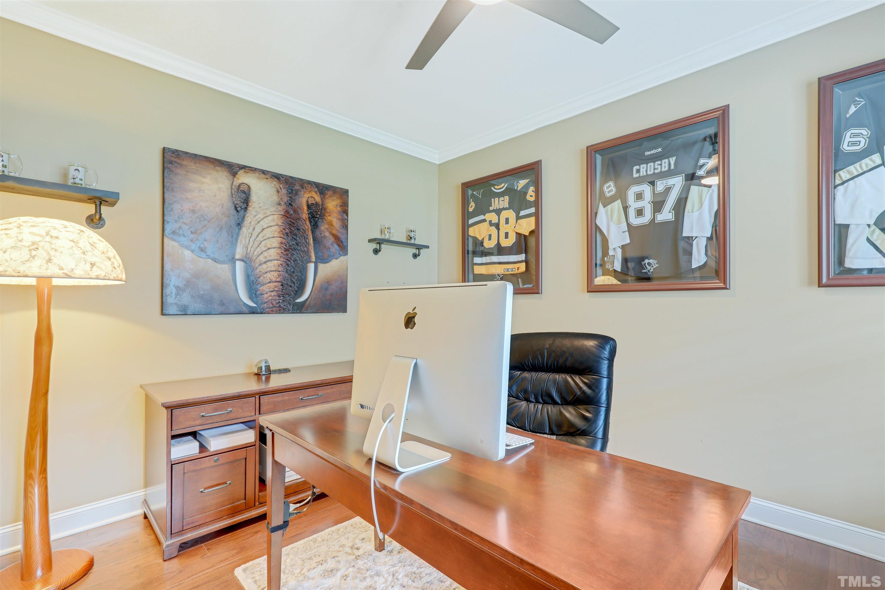 4312 Glengrove Road Raleigh, NC 27616 - Photo 3 of 50 a workspace with furniture and paintings on the wall