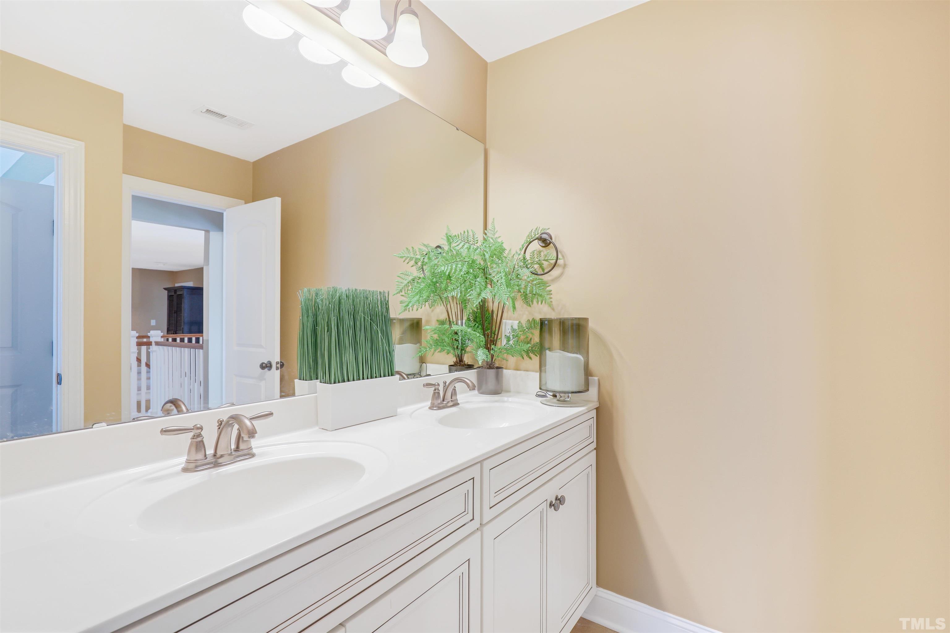 4312 Glengrove Road Raleigh, NC 27616 - Photo 32 of 50 a bathroom with a sink and a mirror