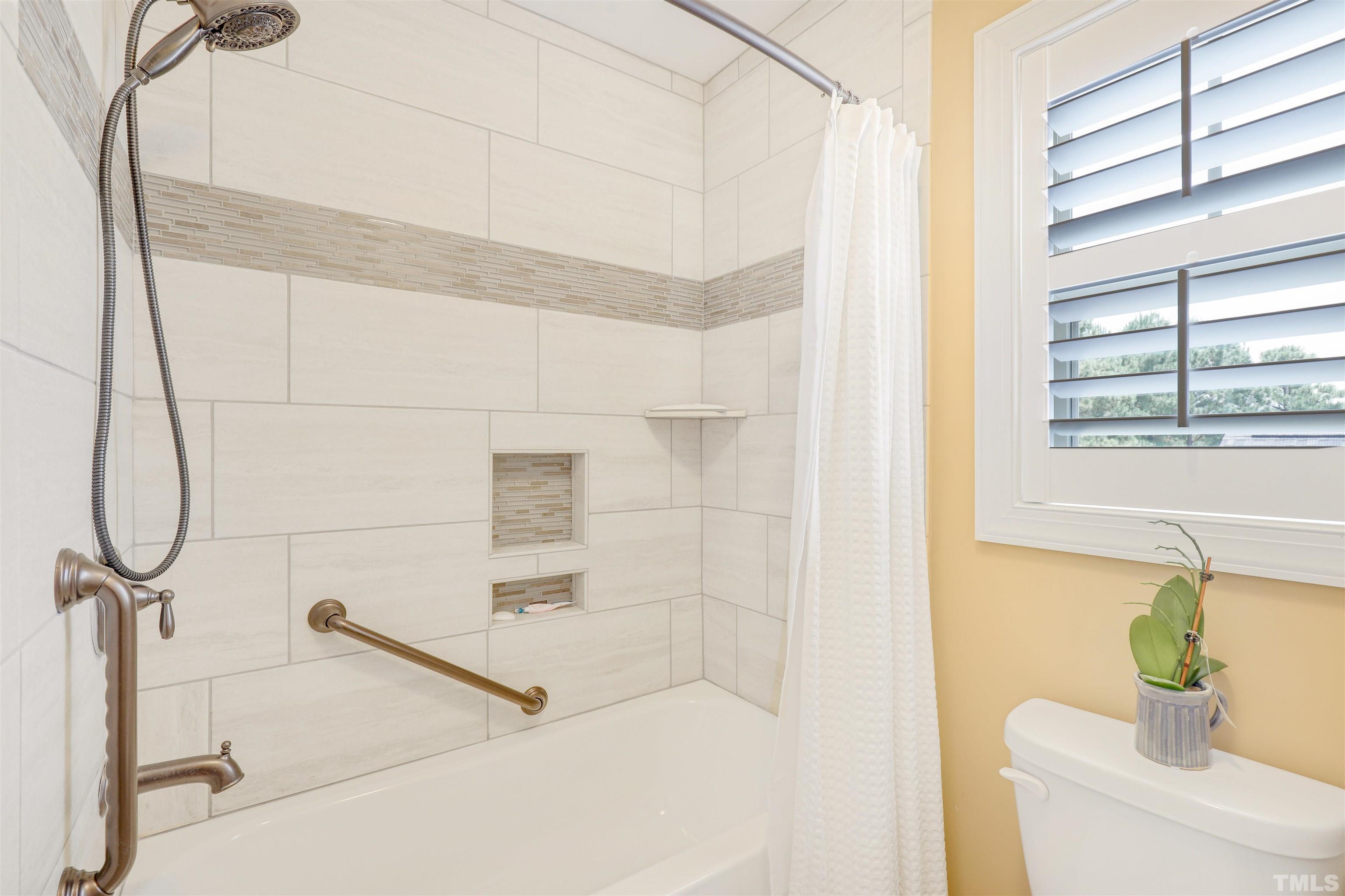 4312 Glengrove Road Raleigh, NC 27616 - Photo 33 of 50 a bathroom with a bathtub and a shower