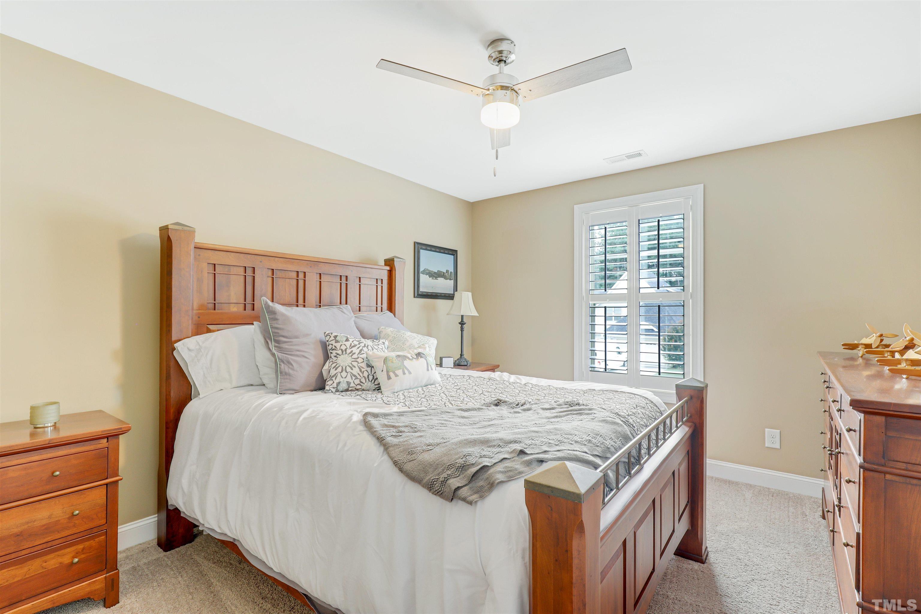 4312 Glengrove Road Raleigh, NC 27616 - Photo 38 of 50 a bedroom with a large bed and a chandelier