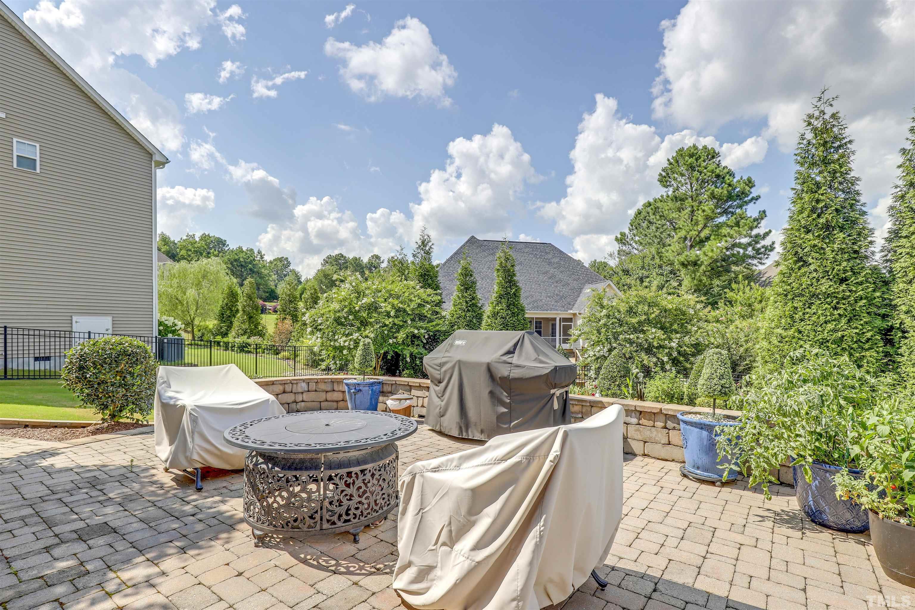 4312 Glengrove Road Raleigh, NC 27616 - Photo 43 of 50 a view of a patio with table and chairs potted plants with sky view