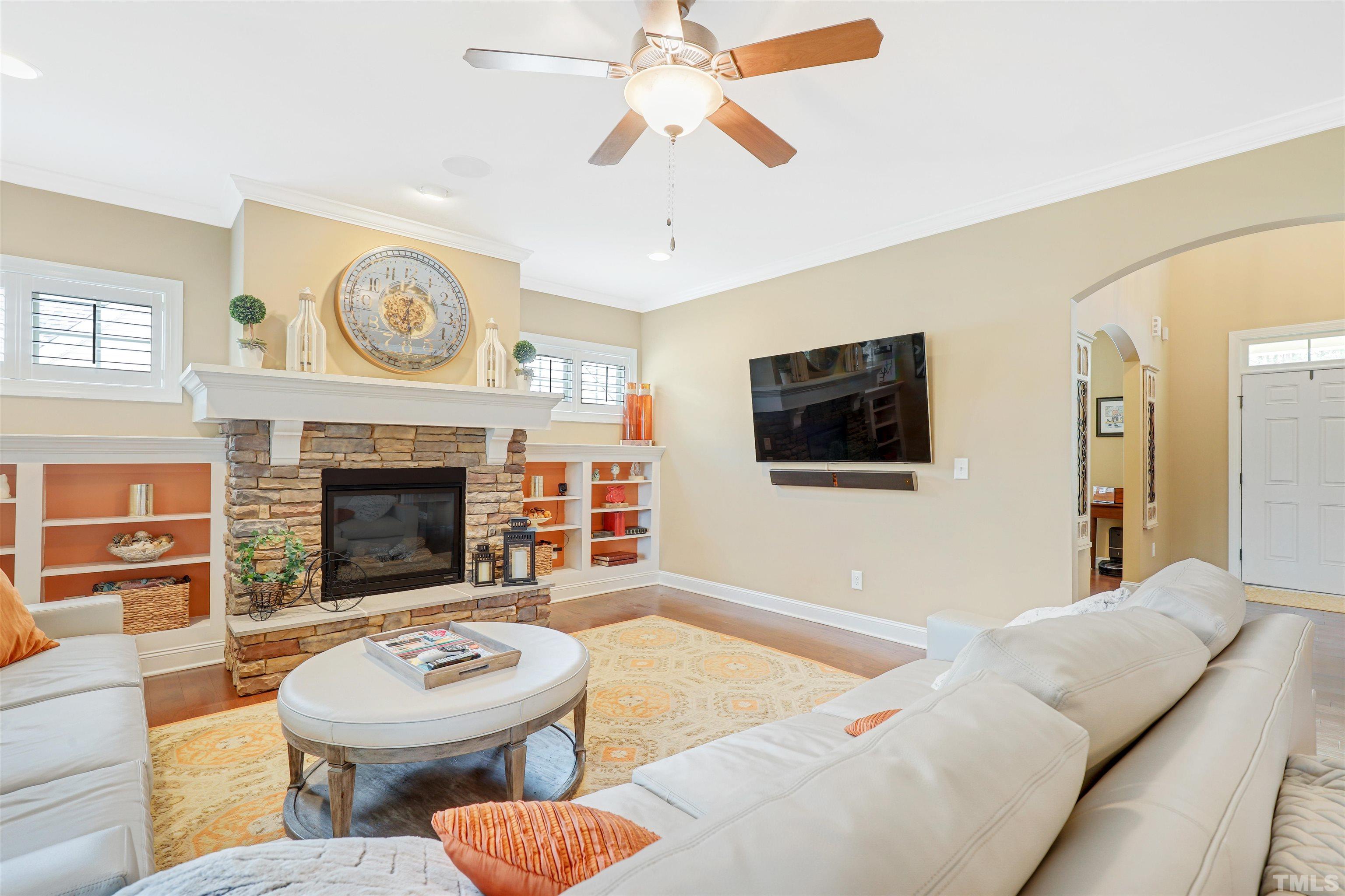 4312 Glengrove Road Raleigh, NC 27616 - Photo 9 of 50 a living room with furniture a flat screen tv and a fireplace