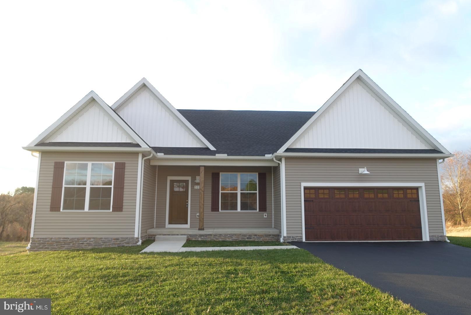 310 Steeple View Drive, Unit 18 Hanover, PA 17331 - Photo 3 of 24 a front view of a house with a yard and garage