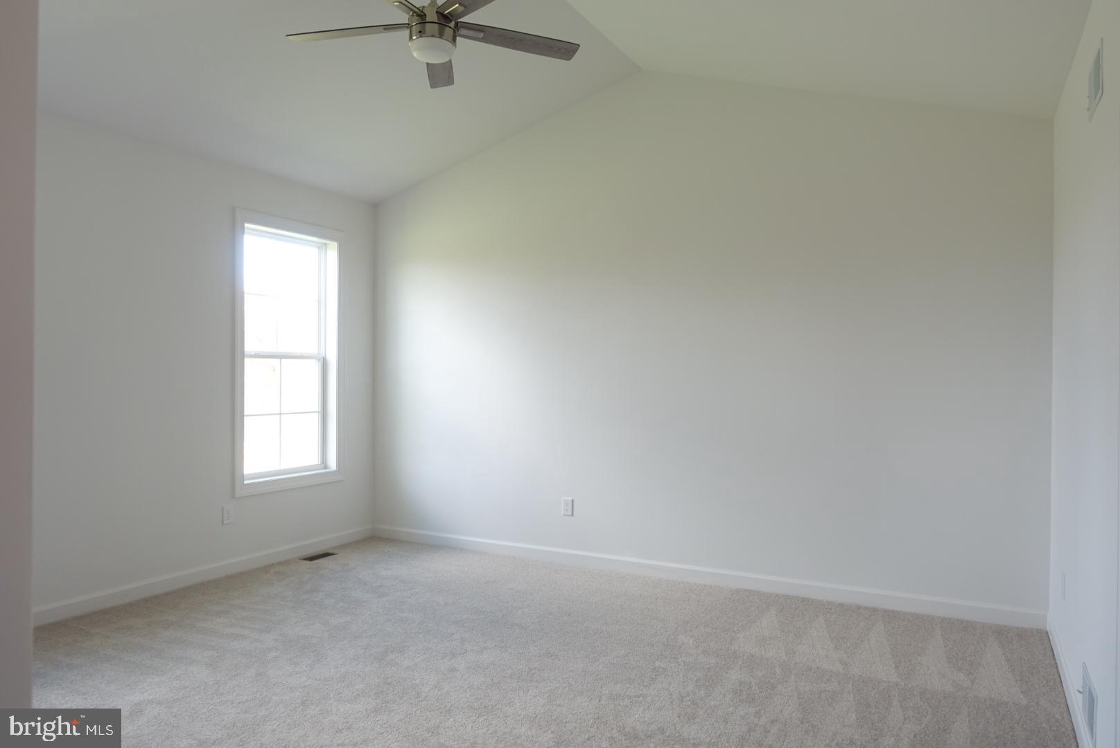 310 Steeple View Drive, Unit 18 Hanover, PA 17331 - Photo 10 of 24 an empty room with a window and a fan