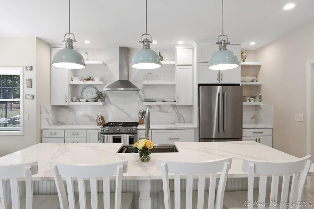 30 Folly Mill Road Salisbury, MA 01952 - Photo 12 of 42 a kitchen that has a lot of white cabinets and stainless steel appliances