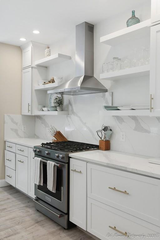 30 Folly Mill Road Salisbury, MA 01952 - Photo 14 of 42 a kitchen with white cabinets and a stove