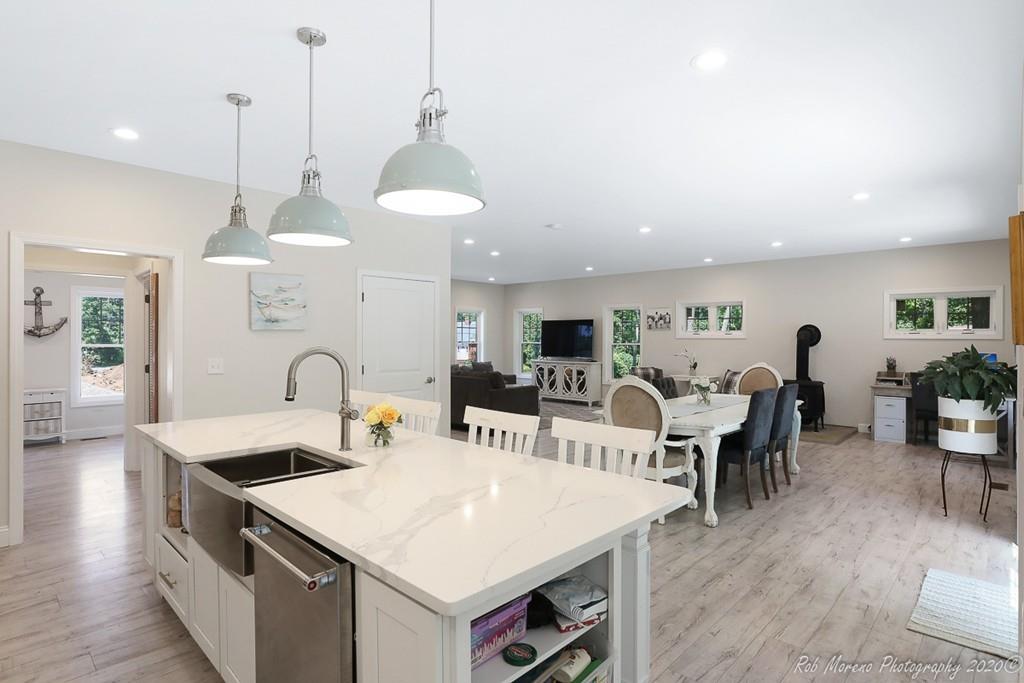 30 Folly Mill Road Salisbury, MA 01952 - Photo 16 of 42 a large kitchen with kitchen island a dining table chairs and a wooden floor
