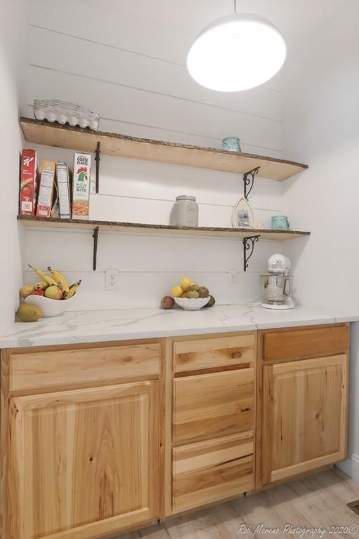 30 Folly Mill Road Salisbury, MA 01952 - Photo 19 of 42 a kitchen with white cabinets and a wooden floor
