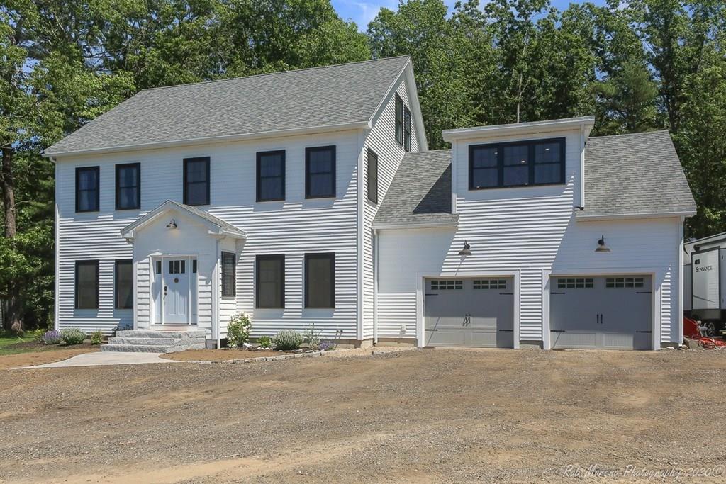 30 Folly Mill Road Salisbury, MA 01952 - Photo 3 of 42 a front view of a house with a road and garage
