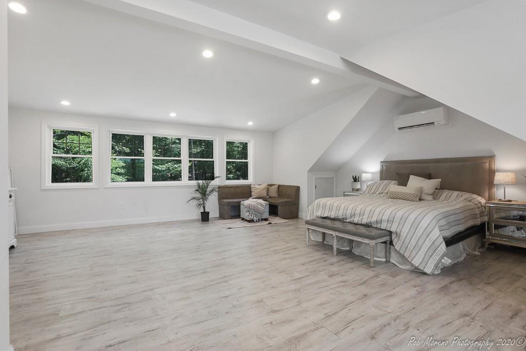 30 Folly Mill Road Salisbury, MA 01952 - Photo 31 of 42 a spacious bedroom with a large bed and a large window