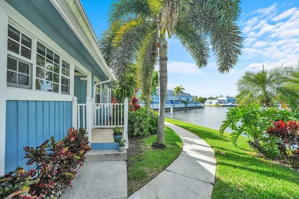 a view of a house with a garden and pathway