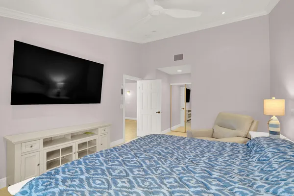 a bedroom with a bed and a flat screen tv