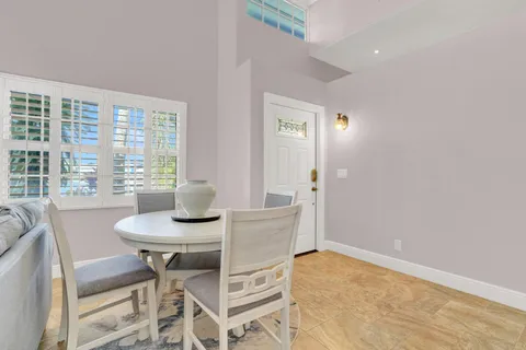 a view of a dining room with furniture and window
