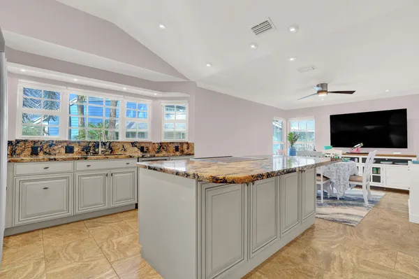 a kitchen with stainless steel appliances granite countertop a stove and a sink