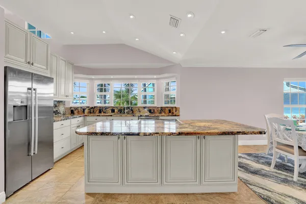 a kitchen with stainless steel appliances granite countertop a stove and a sink