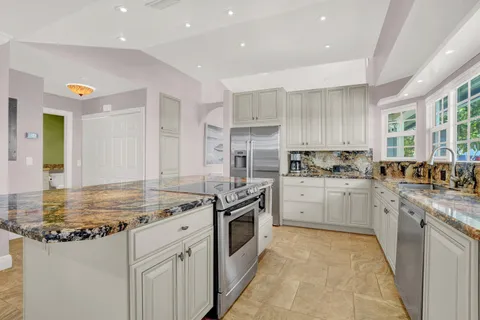 a kitchen with a sink stove and refrigerator
