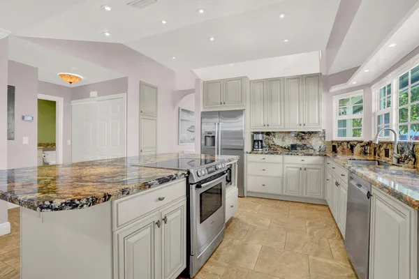 a kitchen with a sink stove and refrigerator