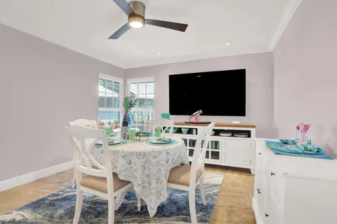 a view of a dining room and kitchen with a table chairs