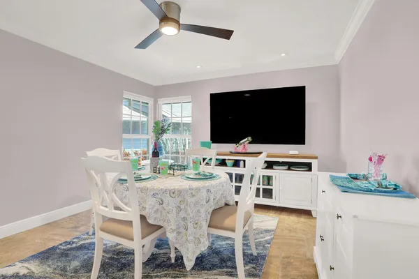 a view of a dining room and kitchen with a table chairs