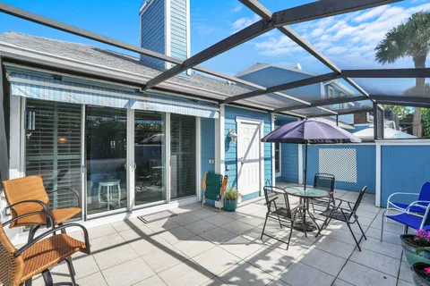 a view of a patio with a table and chairs under an umbrella