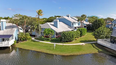 an aerial view of residential houses with outdoor space and seating