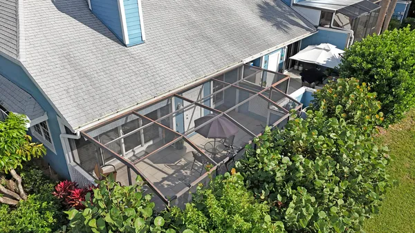 an aerial view of a house with a swimming pool