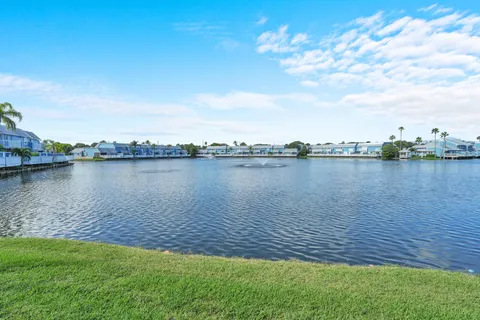 a view of a lake with houses in the back