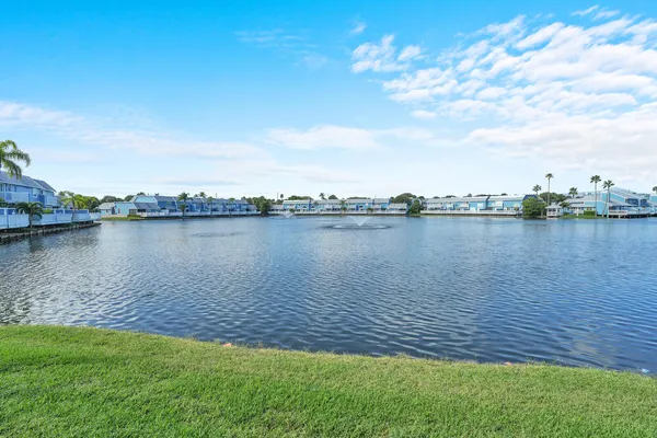 a view of a lake with houses in the back