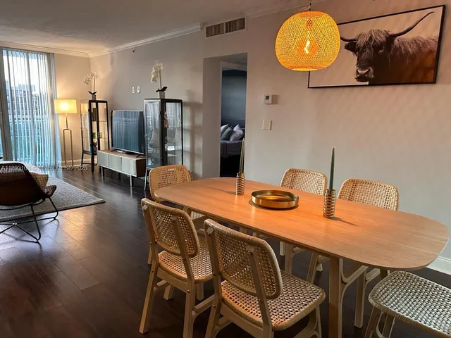 a dining room with furniture and wooden floor