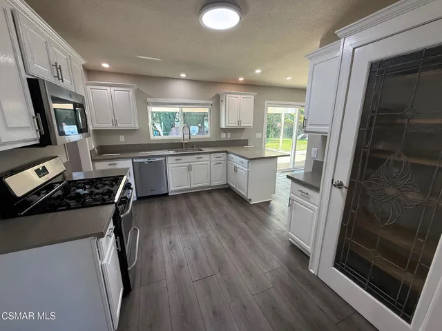 a kitchen with a sink stove and refrigerator