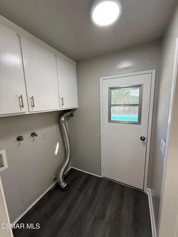 a room with wooden floor and cabinets