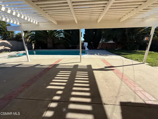 a view of a backyard with sitting area