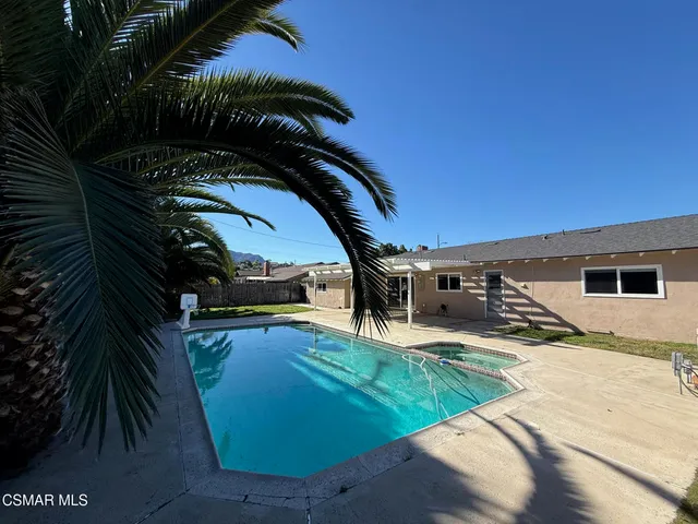 a view of a house with a backyard