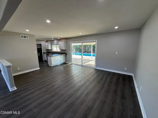 a view of kitchen and dining room with wooden floor
