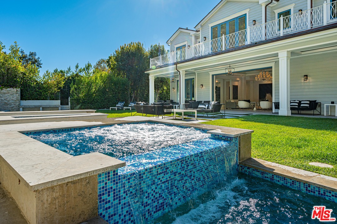 930 Roscomare Road Los Angeles, CA 90077 - Photo 17 of 54 a view of a house with swimming pool and yard