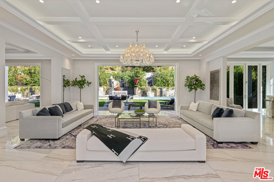930 Roscomare Road Los Angeles, CA 90077 - Photo 21 of 54 a living room with furniture and a chandelier