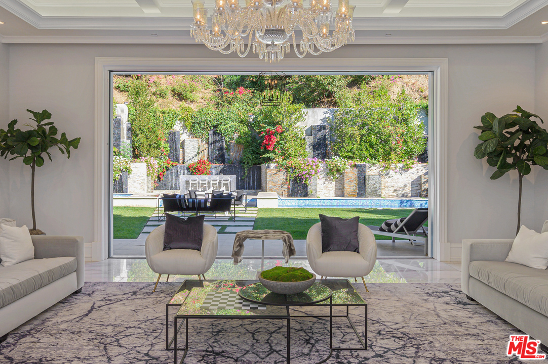 930 Roscomare Road Los Angeles, CA 90077 - Photo 22 of 54 a living room with furniture and a large window