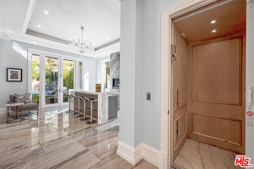 930 Roscomare Road Los Angeles, CA 90077 - Photo 27 of 54 a room with lots of counter space and windows