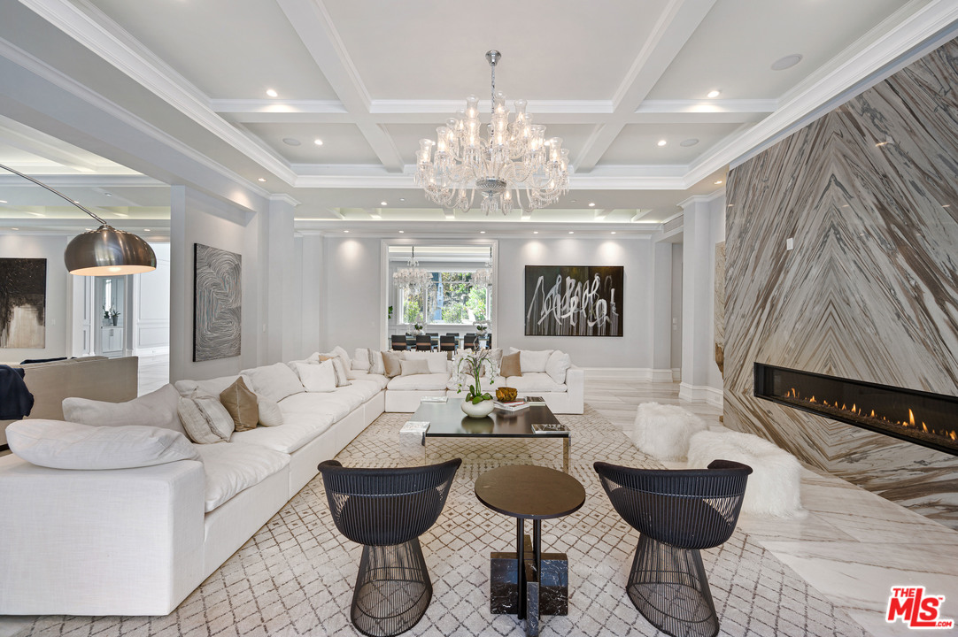 930 Roscomare Road Los Angeles, CA 90077 - Photo 29 of 54 a living room with furniture and a chandelier