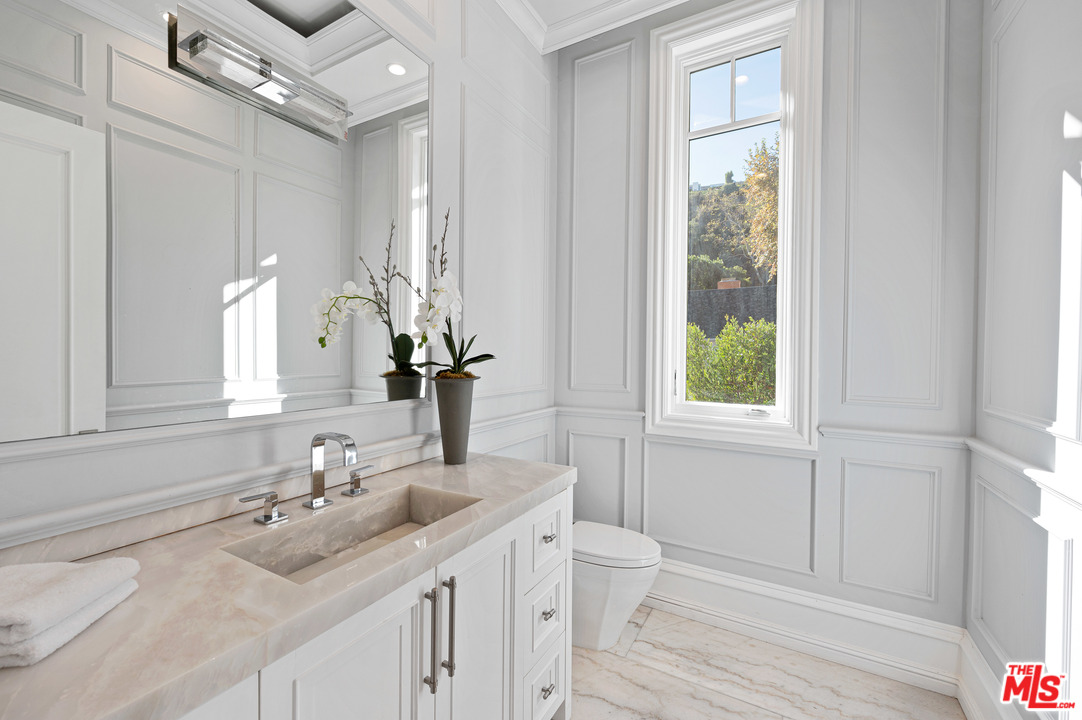 930 Roscomare Road Los Angeles, CA 90077 - Photo 38 of 54 a bathroom with a double vanity sink and a mirror