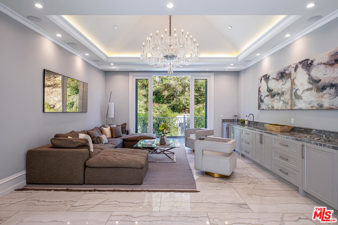 930 Roscomare Road Los Angeles, CA 90077 - Photo 40 of 54 a living room with furniture and a chandelier