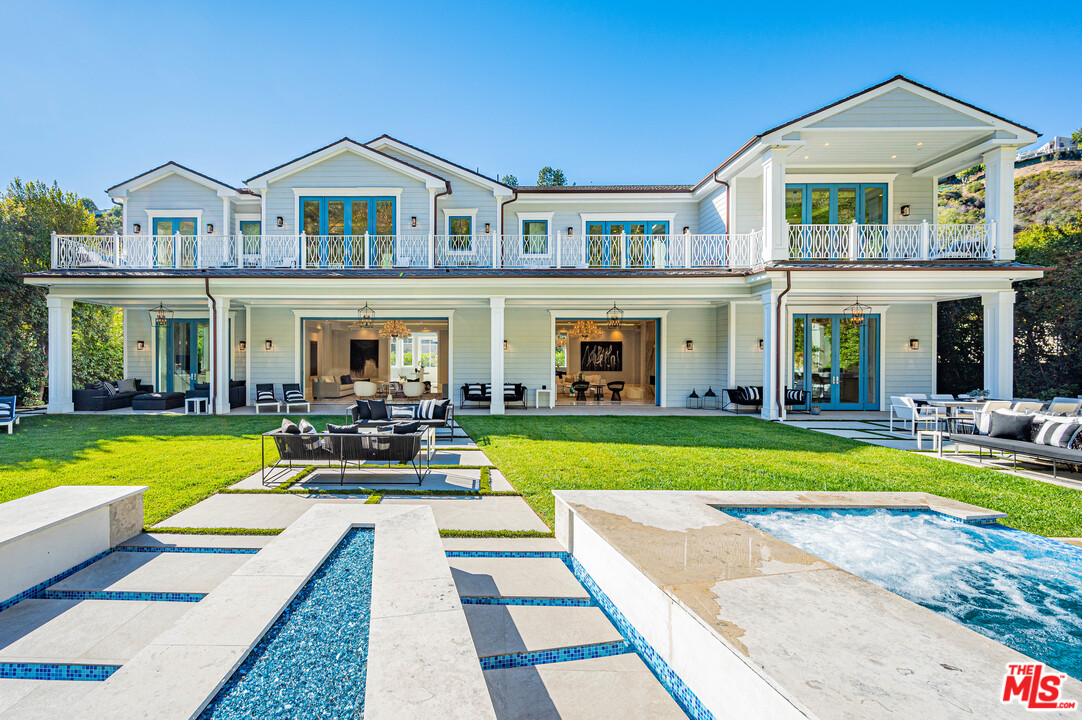 930 Roscomare Road Los Angeles, CA 90077 - Photo 5 of 54 a view of a house with swimming pool yard and a large tree