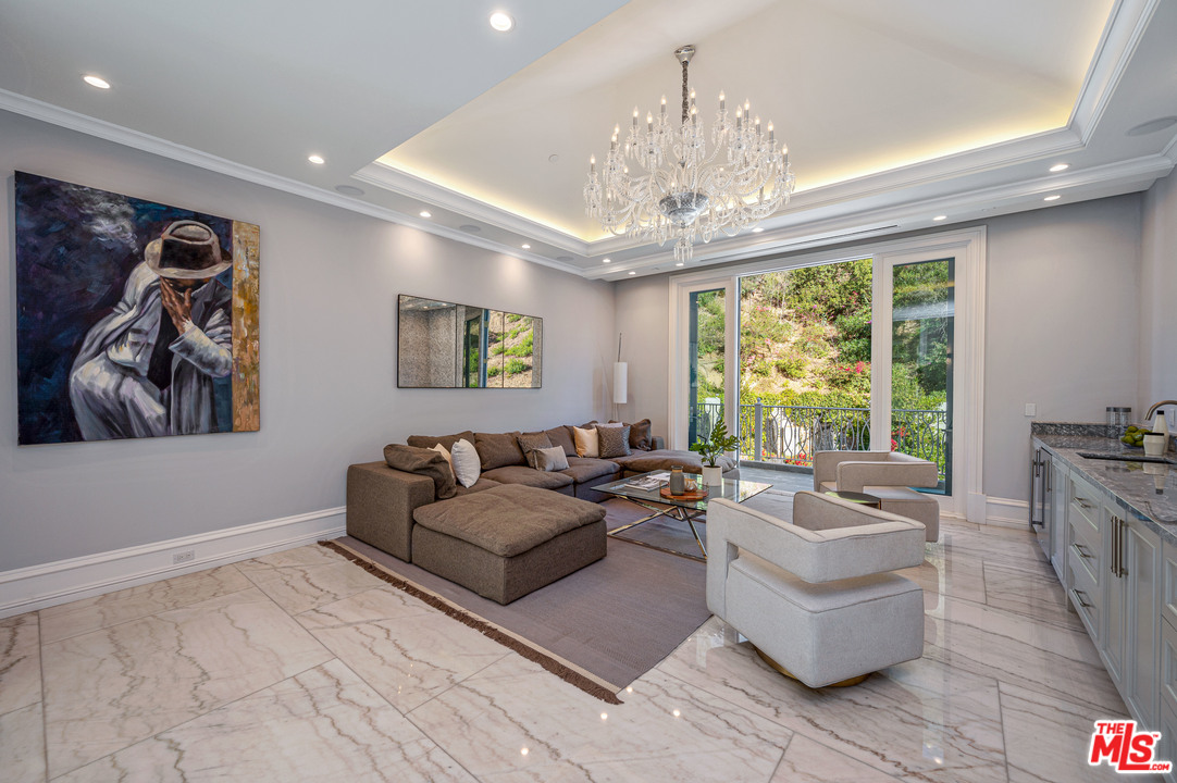 930 Roscomare Road Los Angeles, CA 90077 - Photo 41 of 54 a living room with furniture and a large window