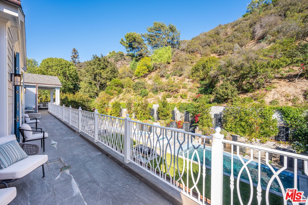 930 Roscomare Road Los Angeles, CA 90077 - Photo 43 of 54 a view of a balcony with wooden fence