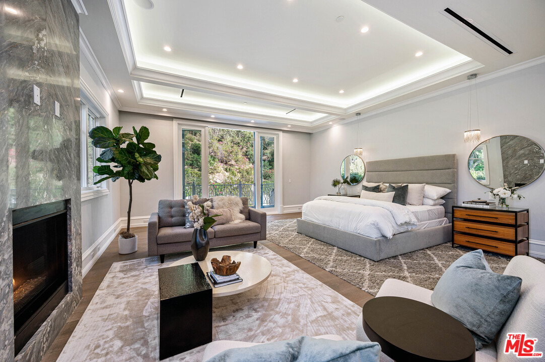 930 Roscomare Road Los Angeles, CA 90077 - Photo 48 of 54 a bedroom with a bed a couch and dresser