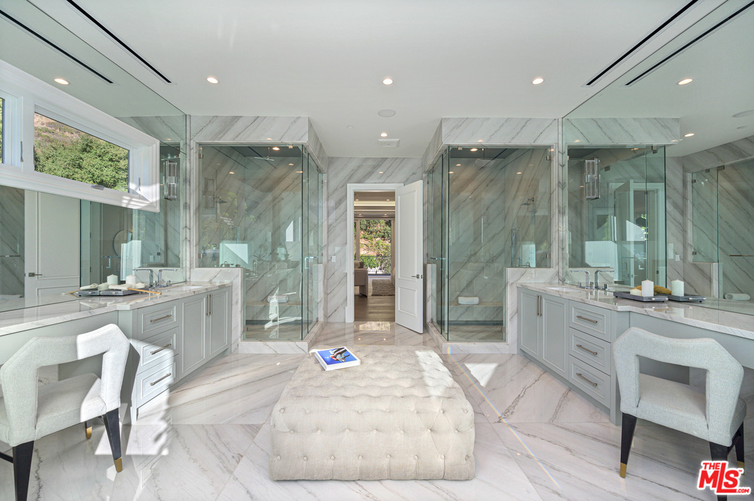 930 Roscomare Road Los Angeles, CA 90077 - Photo 50 of 54 a large bathroom with a granite countertop tub sink shower and mirror