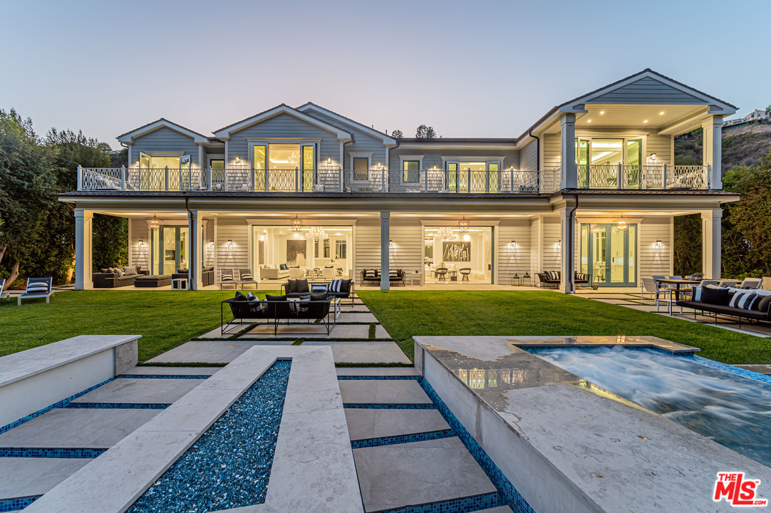 930 Roscomare Road Los Angeles, CA 90077 - Photo 6 of 54 a front view of a house with a yard
